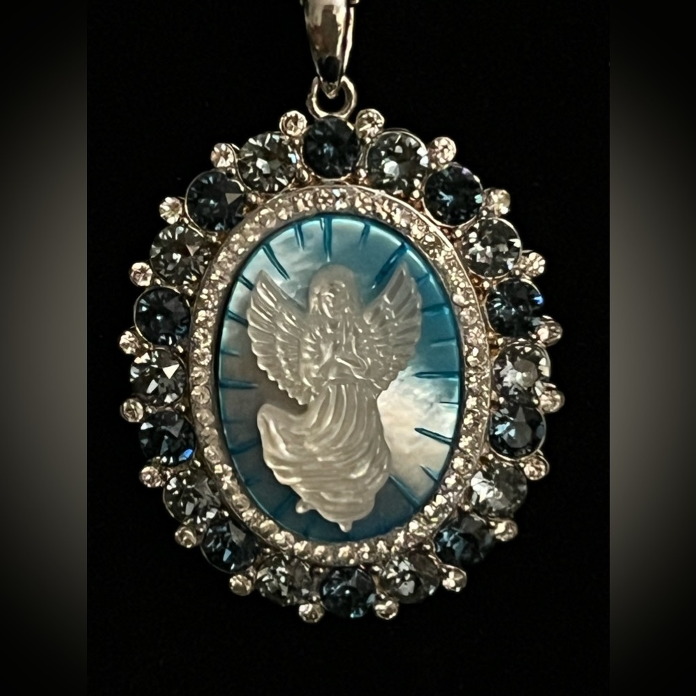 Mother of Pearl Guardian Angel pendant set in sterling. Beautiful.